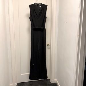 Black sleeveless jumpsuit with tie belt